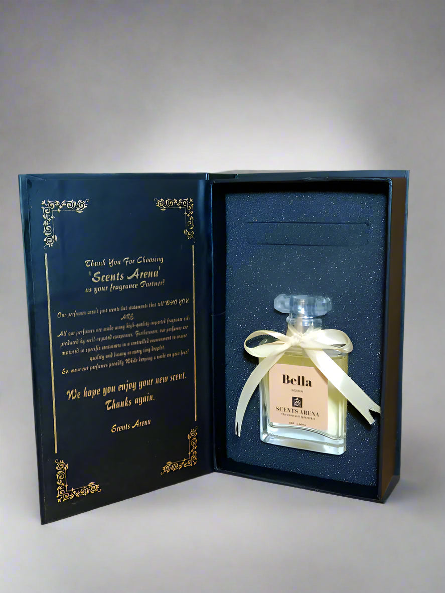 Perfume bottle with 'Bella' label in a decorative box on a wooden surface.
