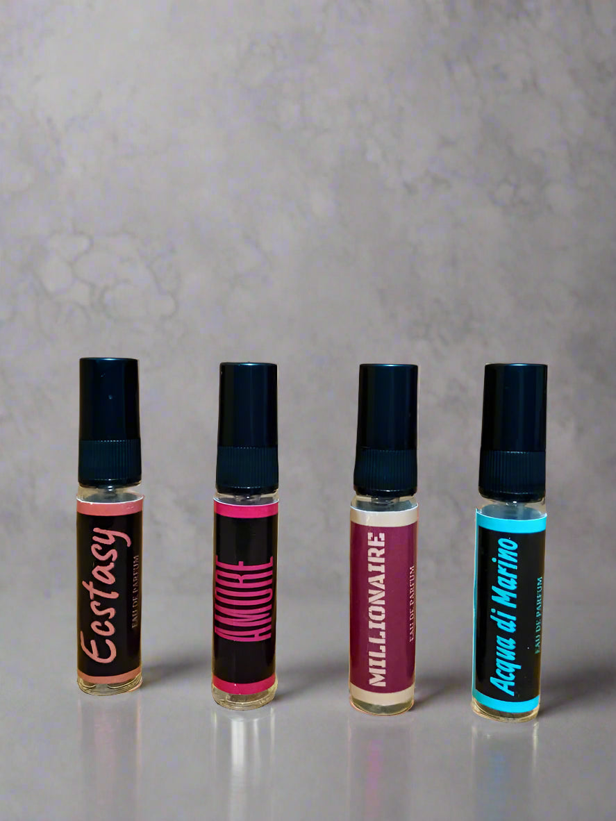 Four small cylindrical containers with black caps on a wooden surface.